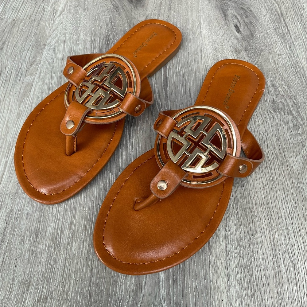 Tan Pierre Dumas limit style slip on sandal with gold emblem detail. TTS